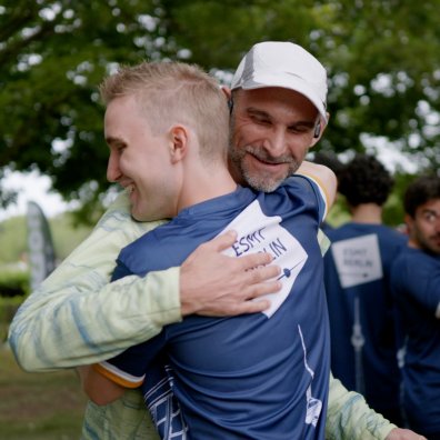 ESMT Berlin professor Eric Quinane hugging a student after a successful relay race