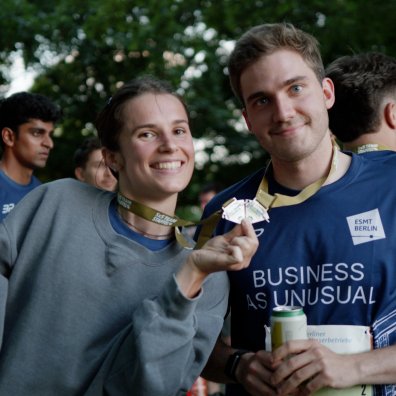 ESMT Berlin students show their medals after running the Berliner Wasserbetriebe 5 x 5 relay race together