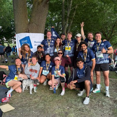 ESMT Berlin students posing during a relay race with the school running club