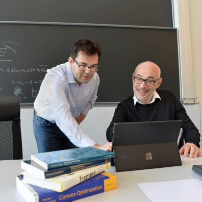 two researchers look at laptop