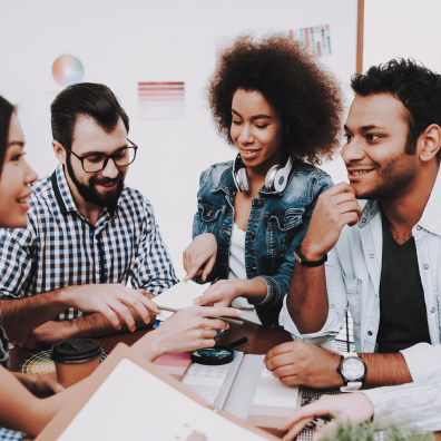 Young diverse team of people working together around a table 