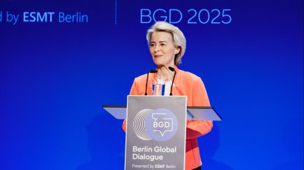 Ursula von der Leyen speaking at Berlin Global Dialogue podium against blue conference backdrop