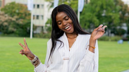 ESMT Berlin Global Online MBA student Joan Mwaniki smiling for the camera while on campus for Berlin Experience Week