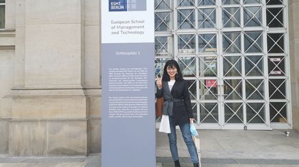 Shiyan Li standing in front of ESMT building