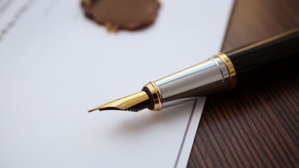 Fountain pen lying on paper on a table 