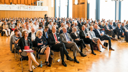 Audience in business attire sitting at a conference