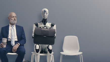 A white male in a business suit and a robot are sitting next to each other waiting for a job interview