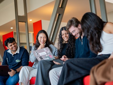 ESMT Berlin master's students laughing together in the campus library