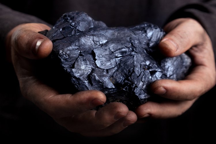 Piece of coal in a man's hands