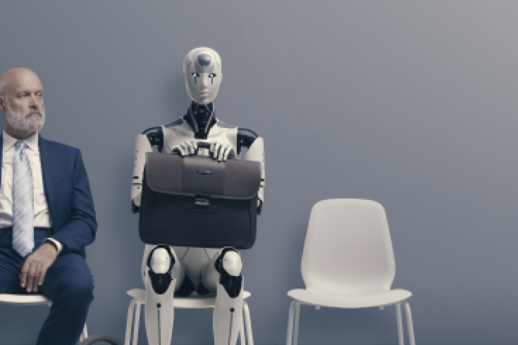 A white male in a business suit and a robot are sitting next to each other waiting for a job interview