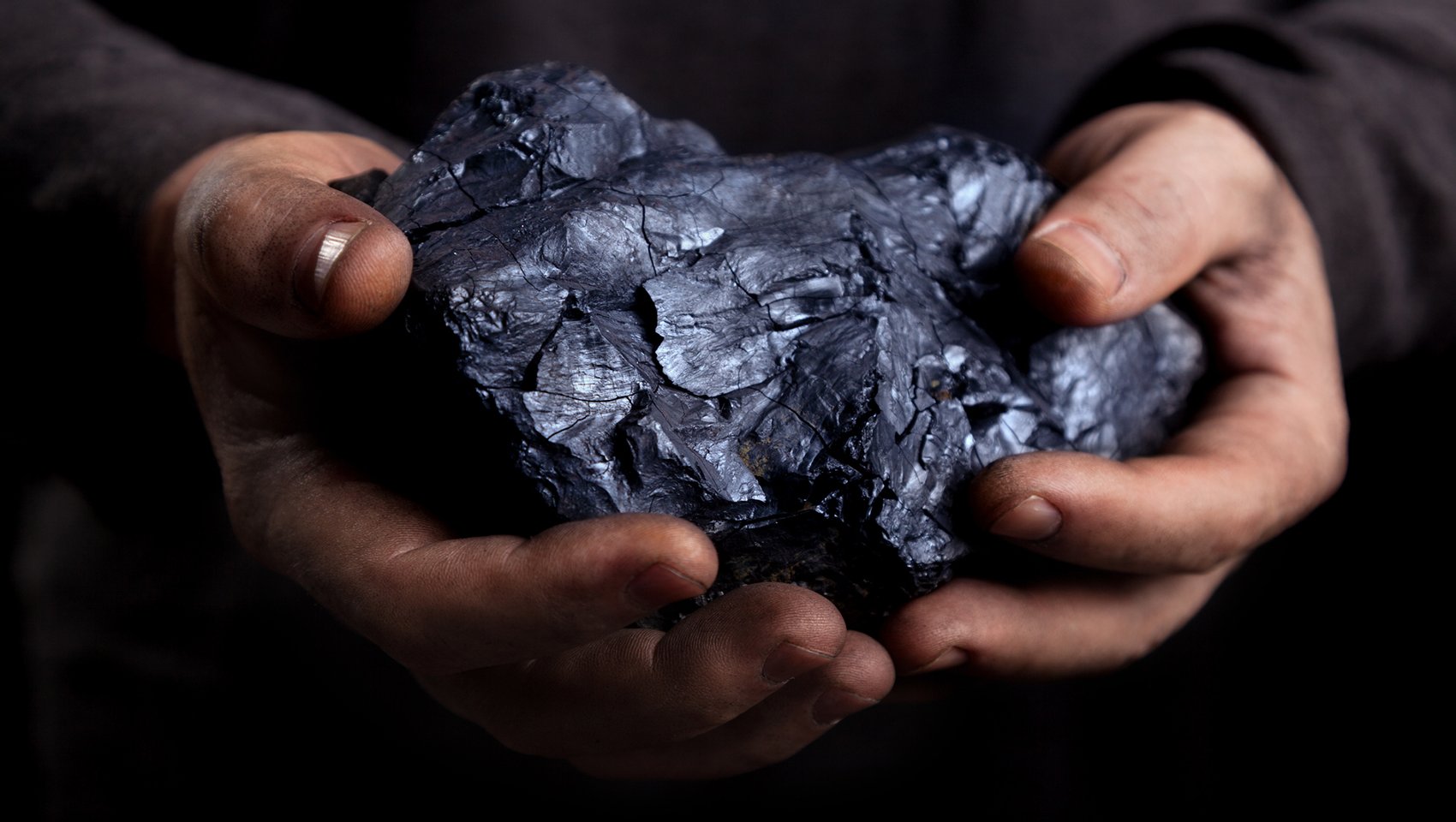Piece of coal in a man's hands
